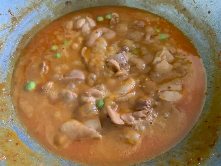 Panang curry sauce thickened and coating tender chicken pieces.
