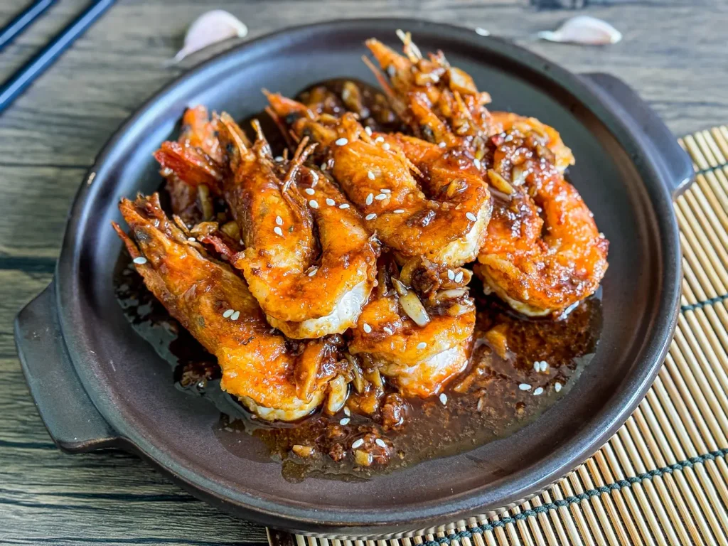 Chinese garlic shrimp drizzled with a thick garlic sauce and sprinkled with sesame seeds.