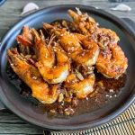 Chinese garlic shrimp drizzled with a thick garlic sauce and sprinkled with sesame seeds.