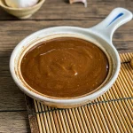 Homemade hoisin sauce served in a small ceramic bowl.