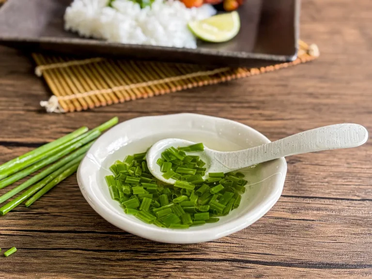 Vietnamese mo hanh scallion oil with chopped green onions in a small white dish, ready to spoon over rice or noodles.