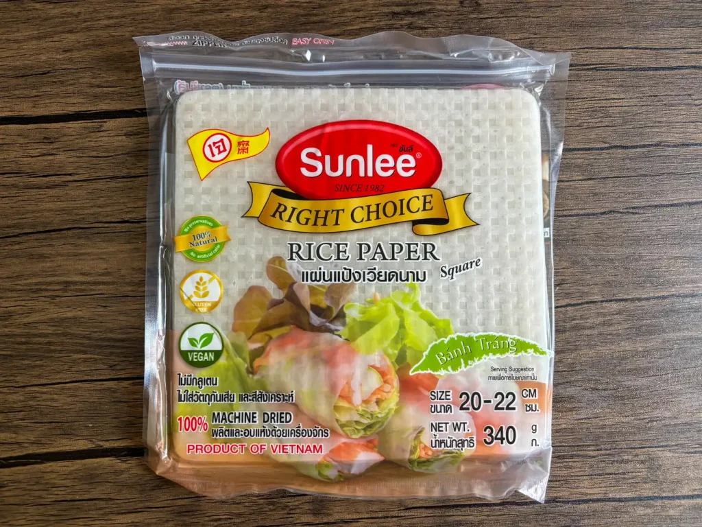 Pack of square rice paper (bánh tráng) for Vietnamese spring rolls, size 20–22 cm, labeled vegan and gluten-free.