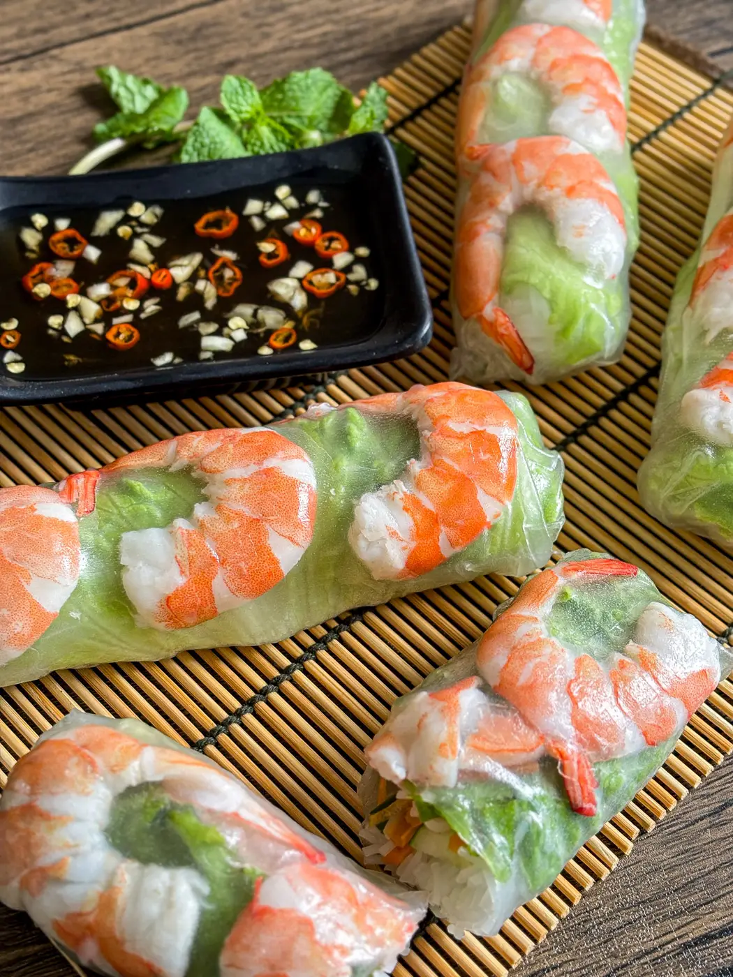 Vietnamese fresh spring rolls with shrimp served with nuoc cham dipping sauce and fresh mint.