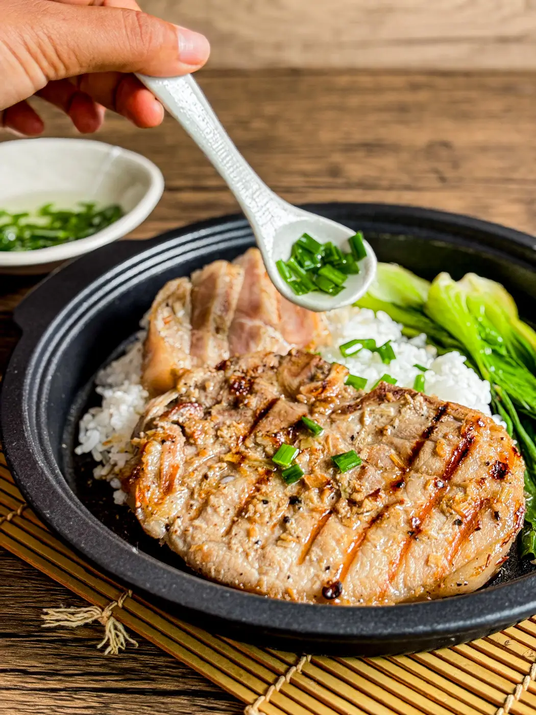 Topping pork chops with Vietnamese scallion oil, mo hanh.