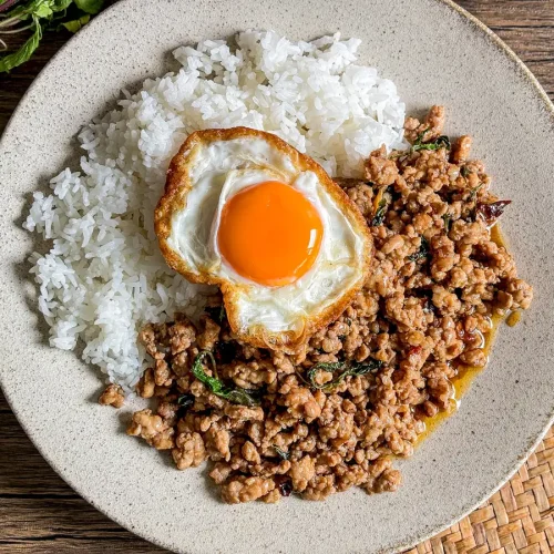 Thai holy basil stir-fry with ground pork, rice, and a crispy fried egg.