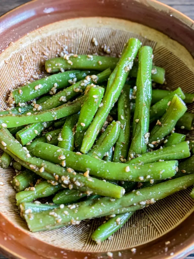 Blanched green beans tossed with sesame dressing inside a Japanese suribachi mortar for gomaae salad.