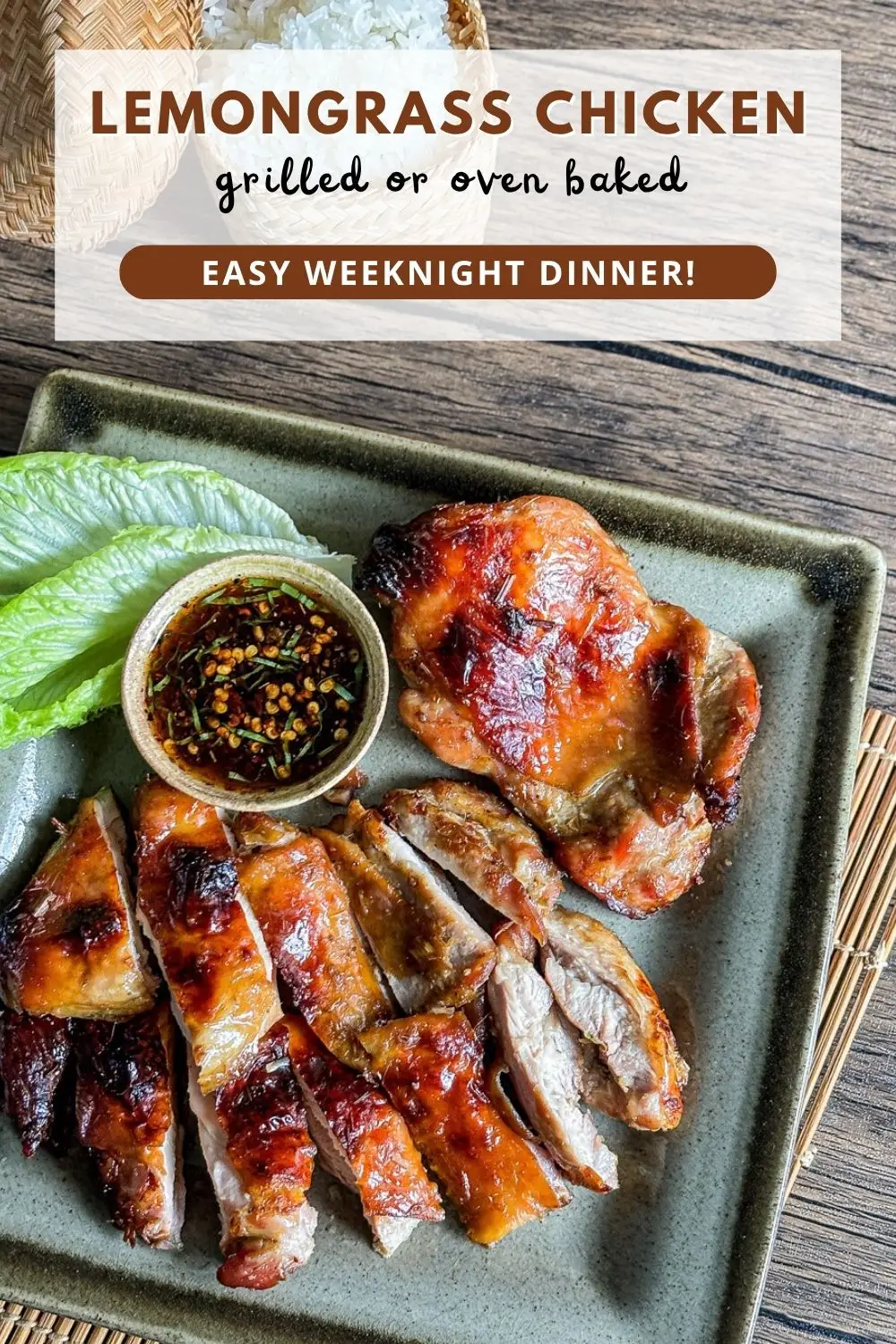 Grilled lemongrass chicken served with dipping sauce and lettuce on a plate, with sticky rice in a basket on the side.