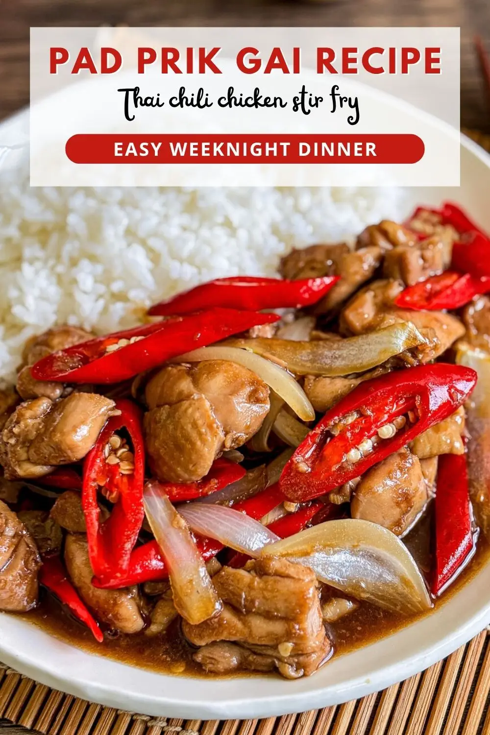 Thai pad prik gai stir fry with chicken, red chilies, and onions served with steamed rice on a white plate.