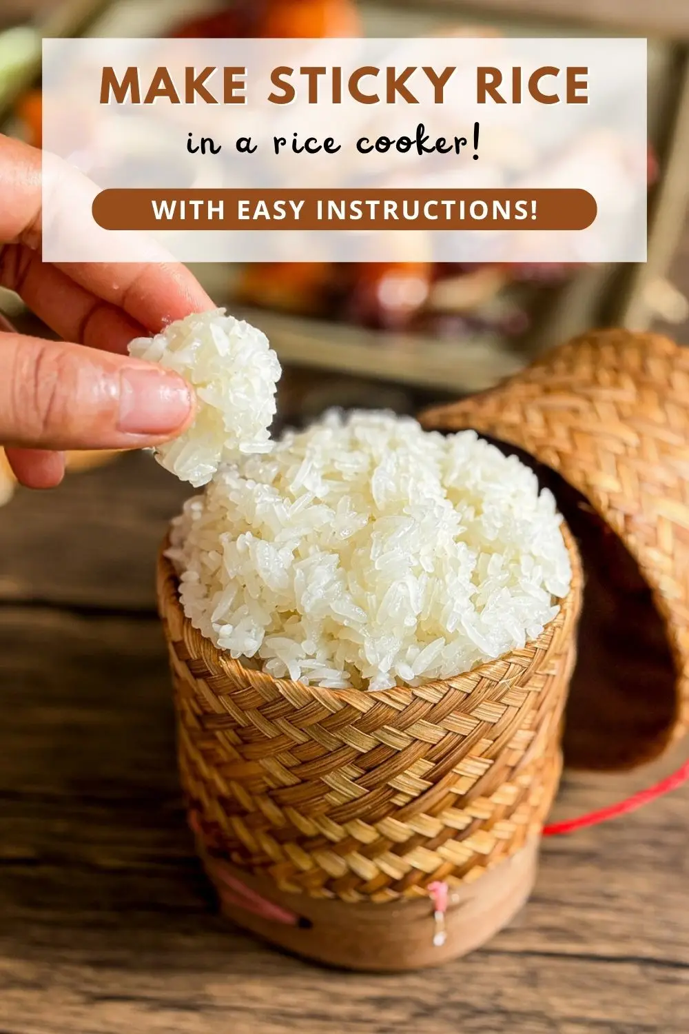 Thai sticky rice served in a bamboo basket, with a hand picking up a portion of rice.