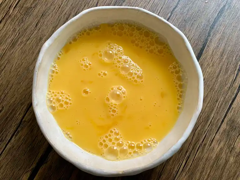 Bowl of beaten eggs.