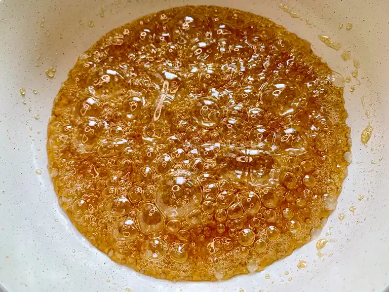 Bubbling caramel sauce in a pan.