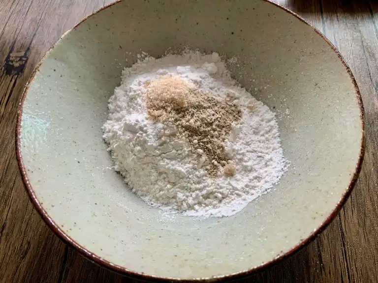 Bowl with tempura flour, bouillon powder, and white pepper.