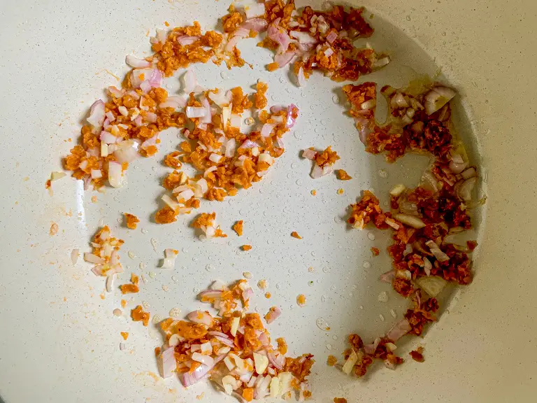 Minced garlic, shallots, and preserved radish frying in oil.