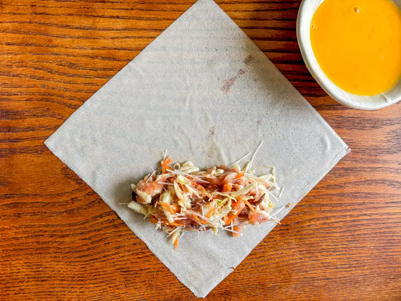 Spring roll filling placed on a wrapper before rolling..