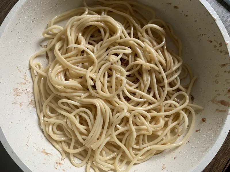 Top-view of yakisoba noodles in a pan.