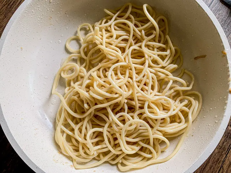 Cooked yakisoba noodles added to the pan for stir-frying.